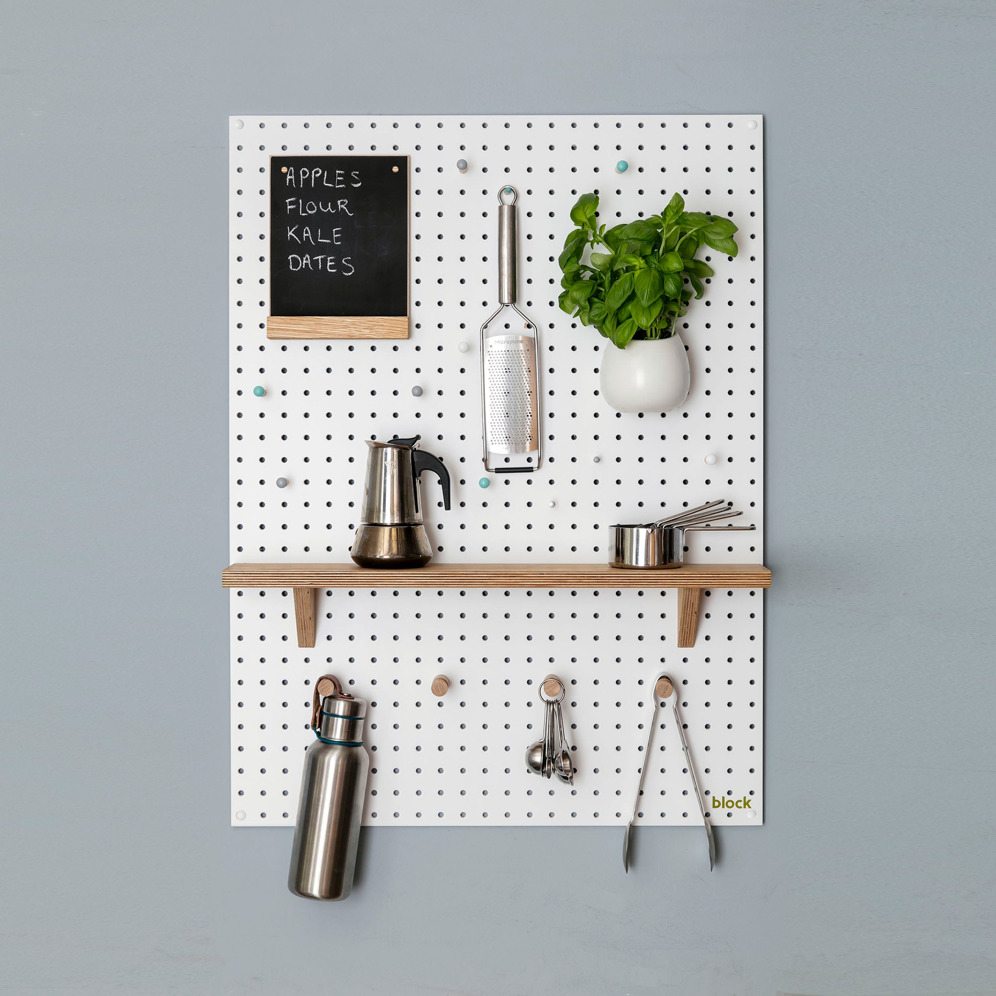 Large white pegboard for kitchen wall storage