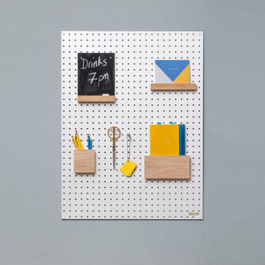 Large white pegboard with wooden pegboard accessories
