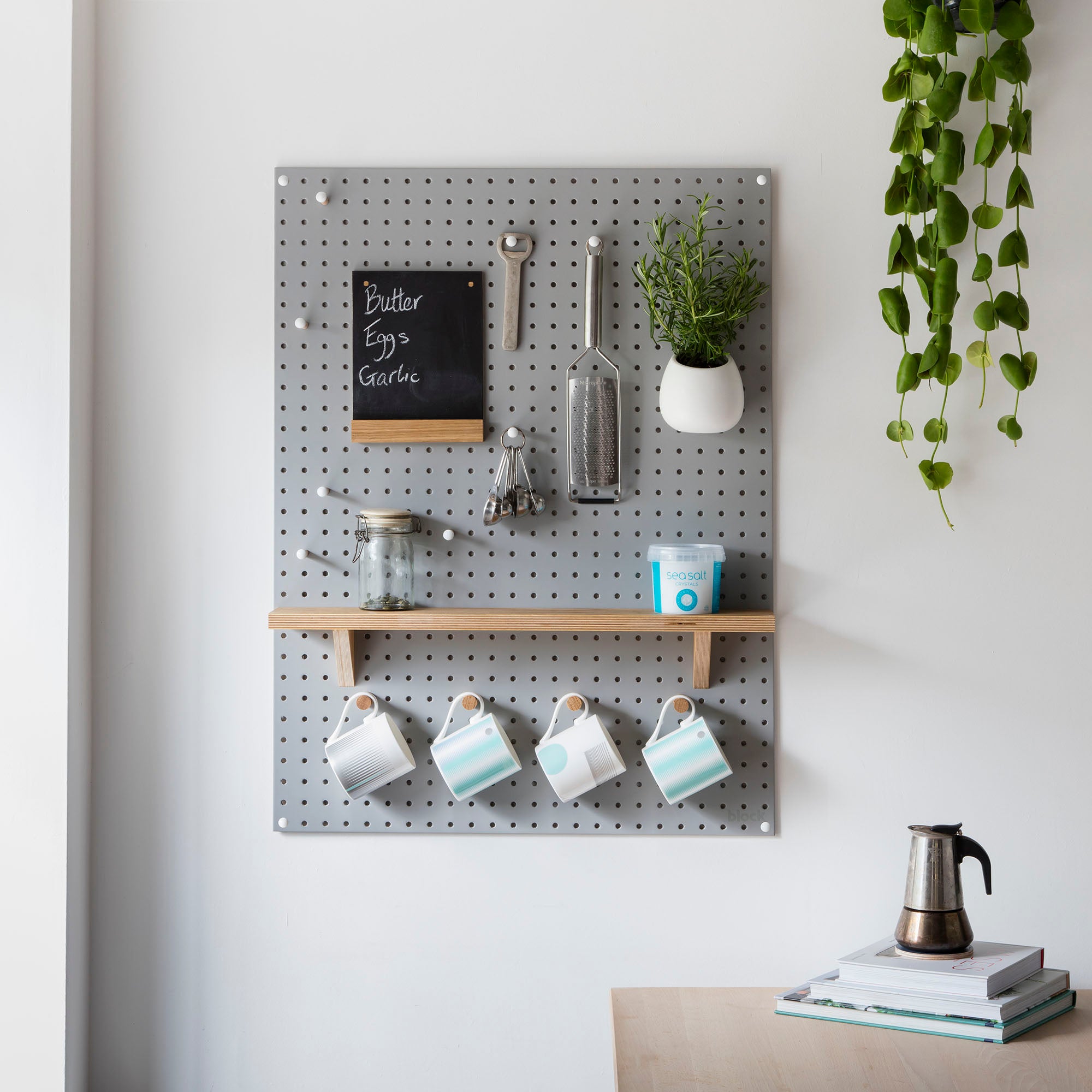 Large grey pegboard wall storage for kitchen