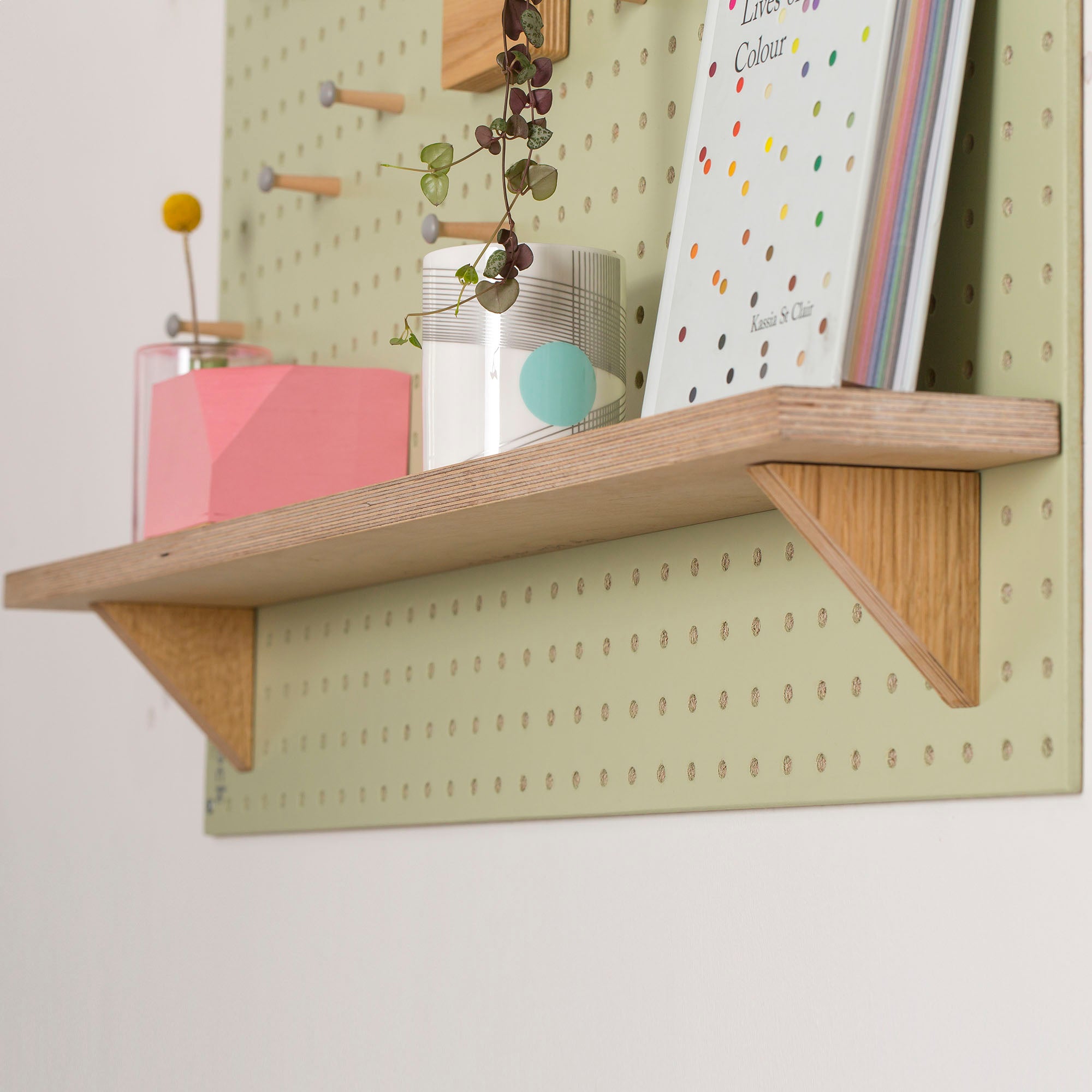 Green-Pegboard-with-fixed-wooden-shelf