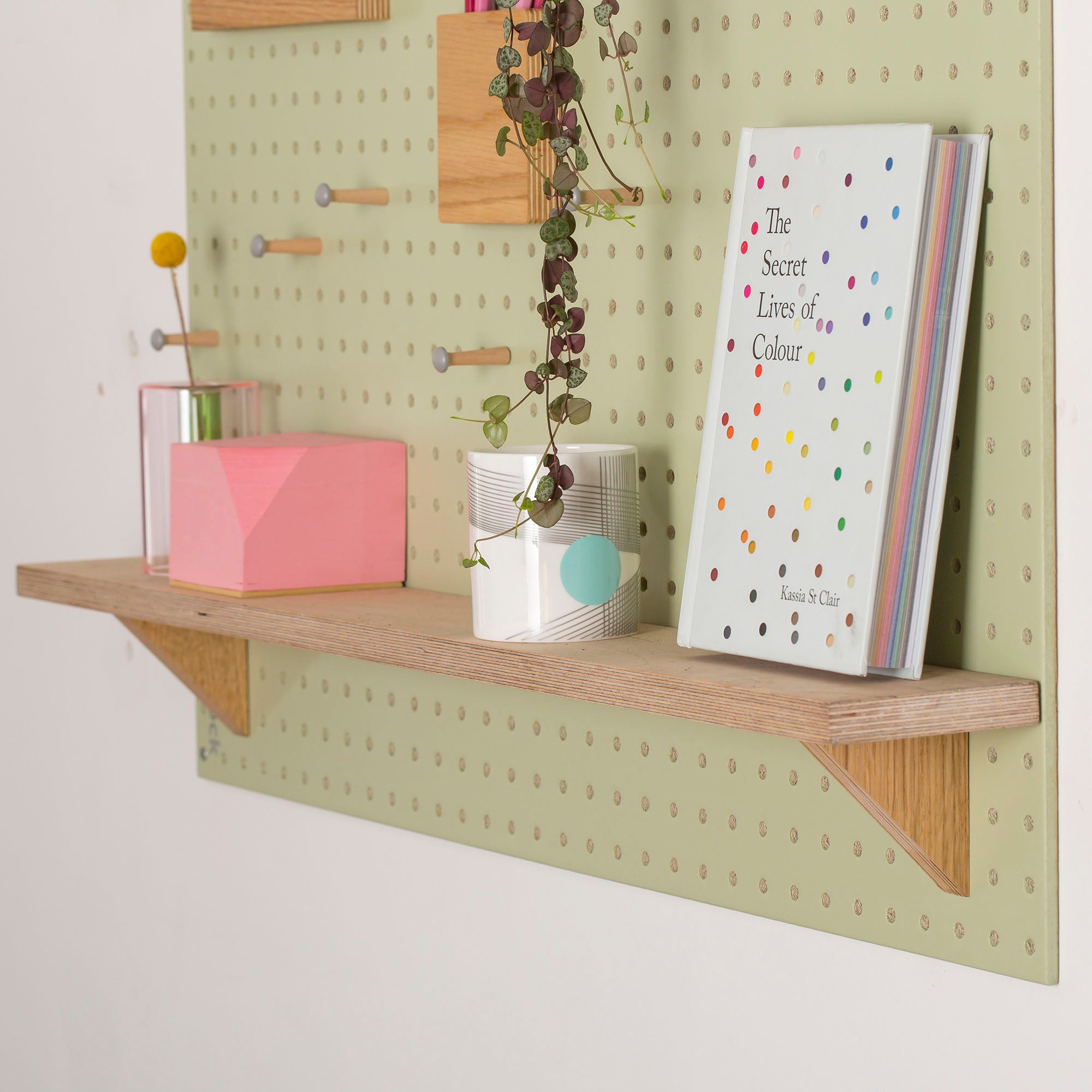 Green-Pegboard-with-fixed-wooden-shelf