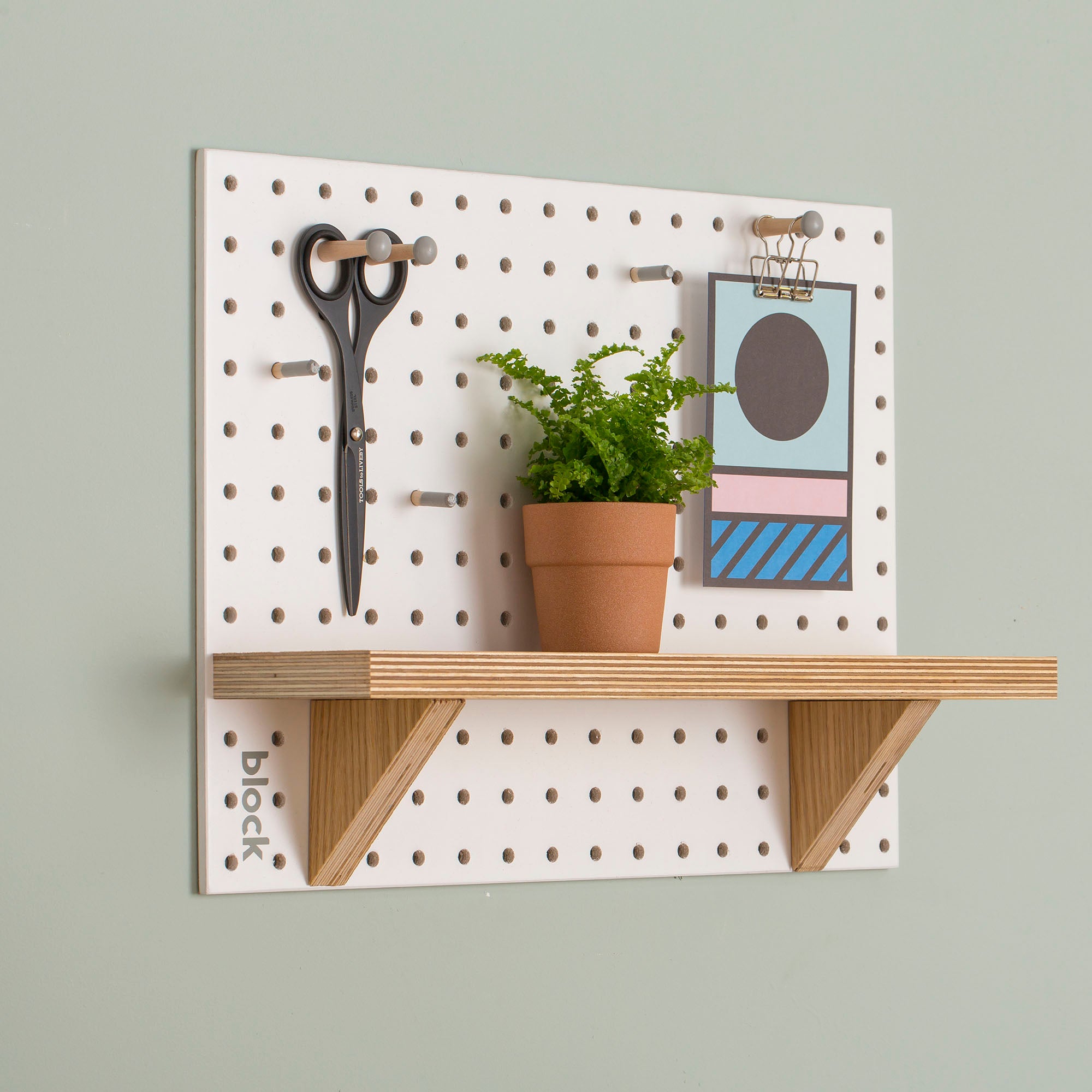 White-Pegboard-with-fixed-wooden-shelf