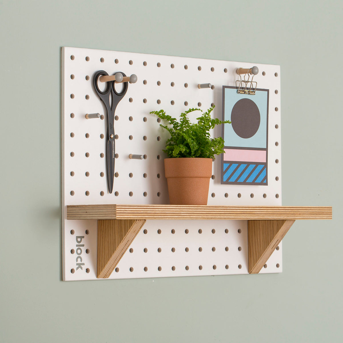 White-Pegboard-with-fixed-wooden-shelf