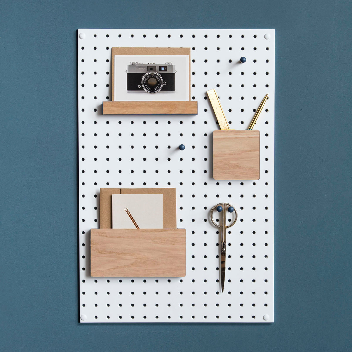 wooden pegboard accessories on white display pegboard