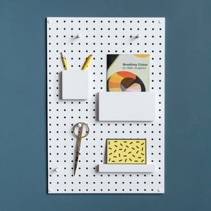 painted white wooden pegboard accessories on white display pegboard