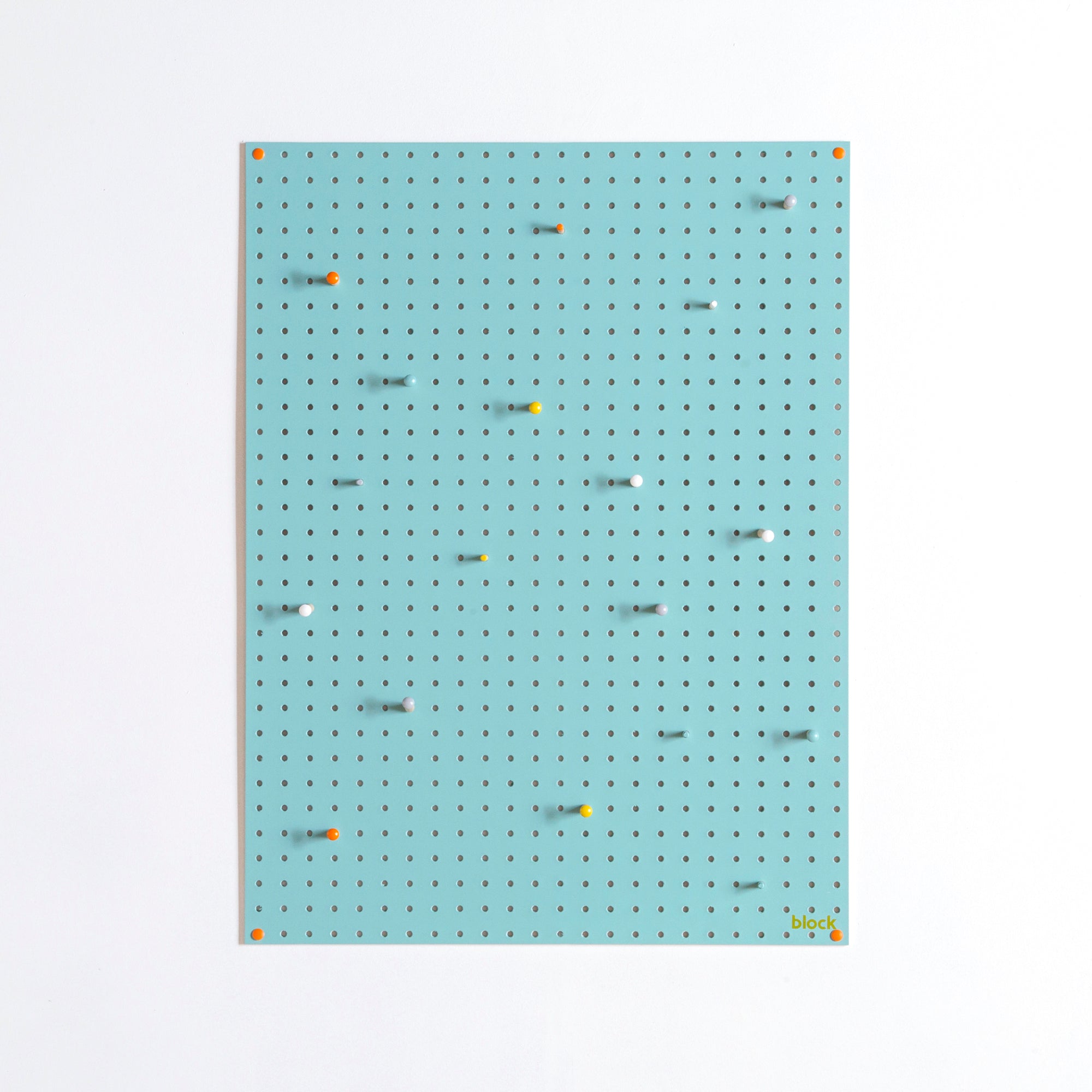 large blue display pegboard with painted wooden pegboard pegs