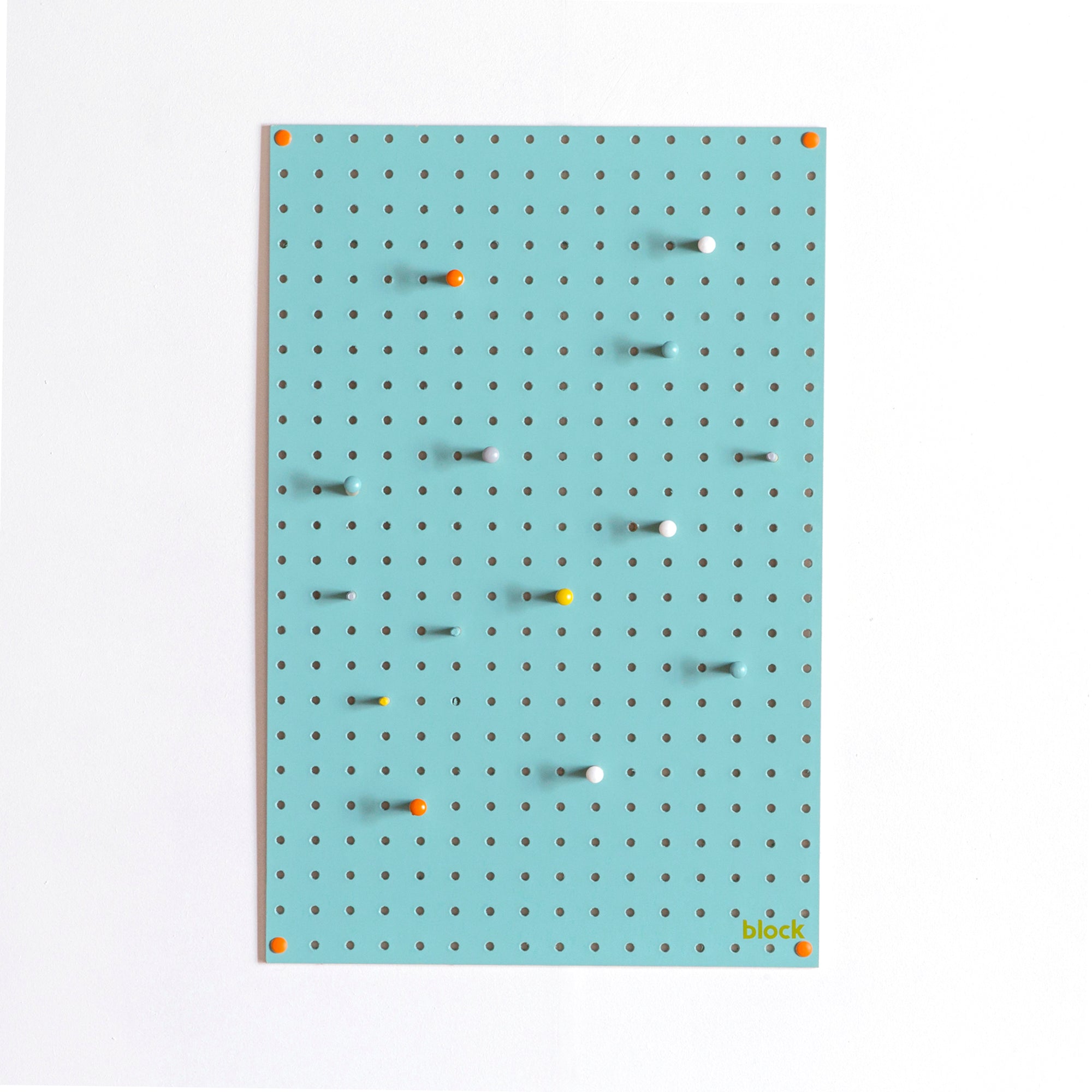 medium blue display pegboard with painted wooden pegboard pegs