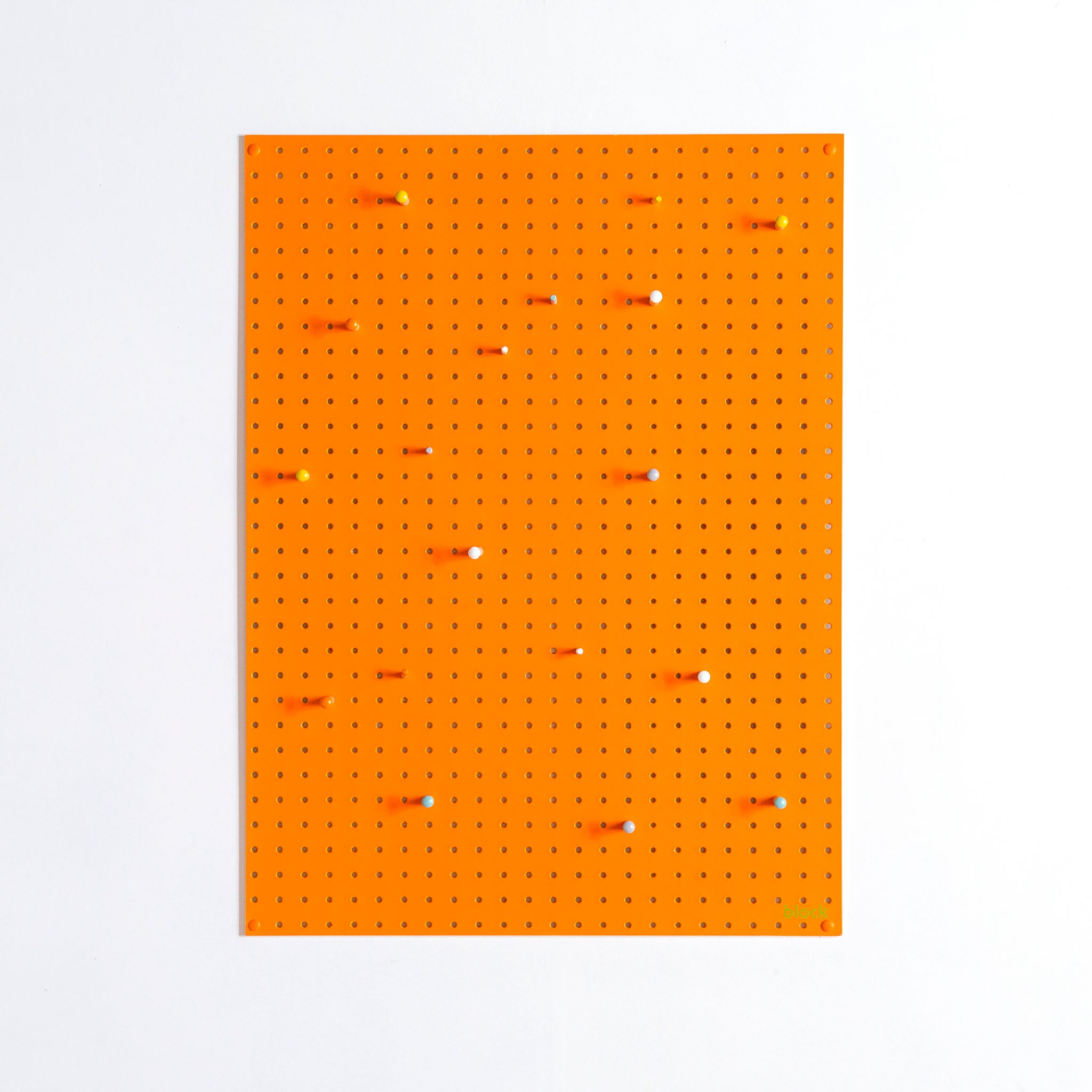 large orange pegboard with wooden pegs