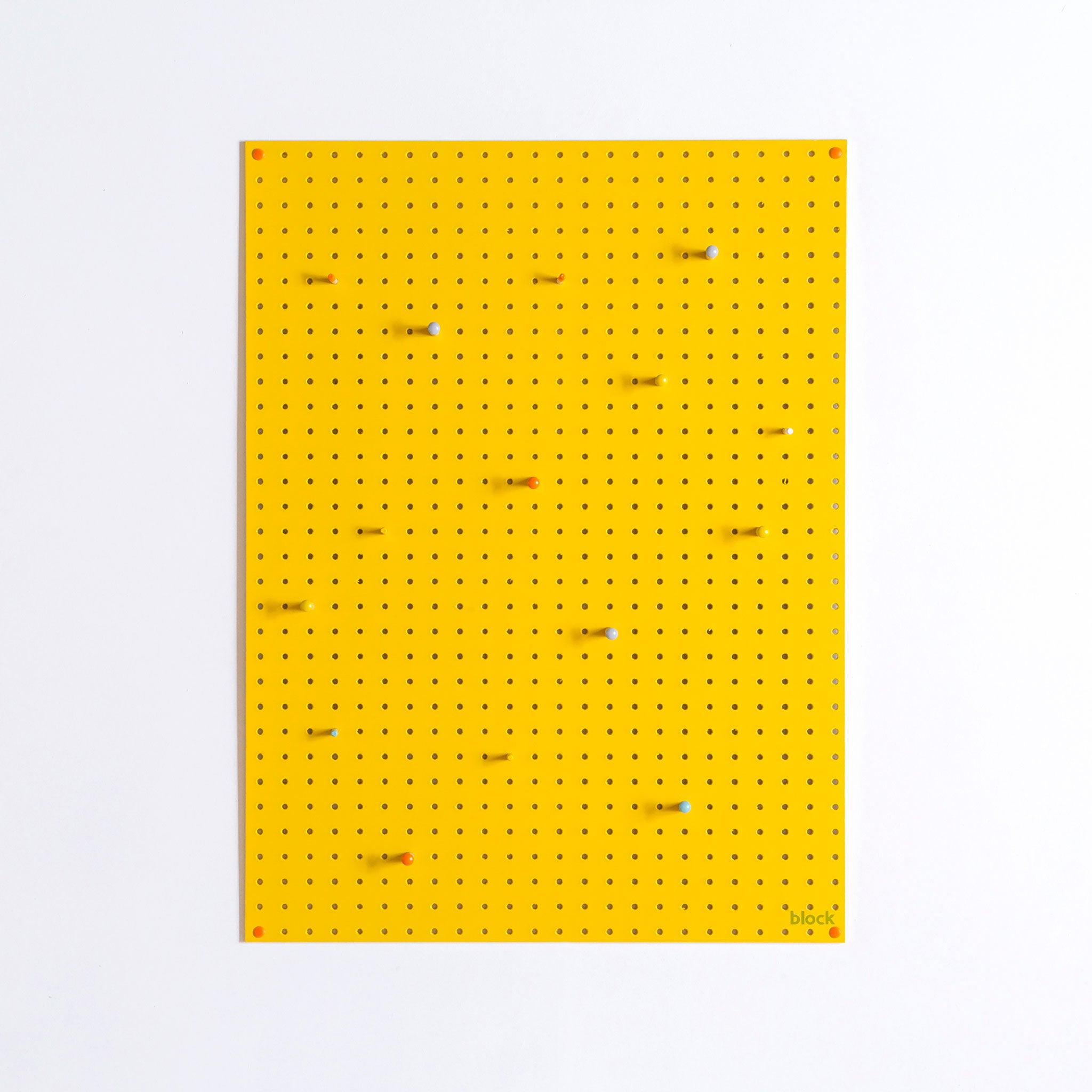 large yellow pegboard with wooden pegs